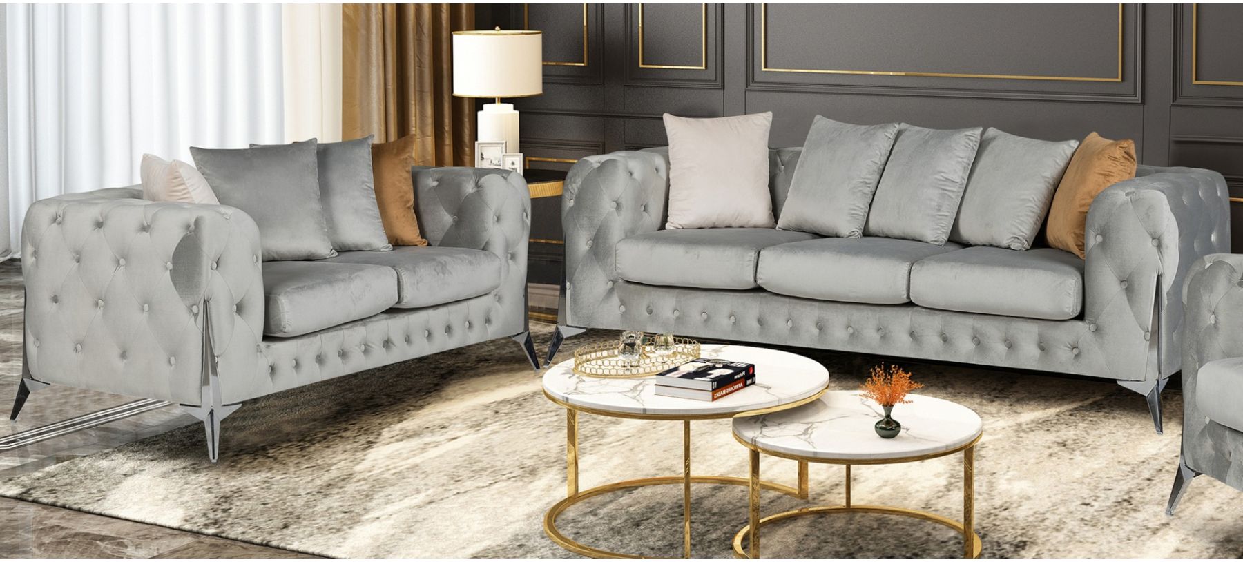 Gray tufted sofa set with a coffee table in a living room setting.